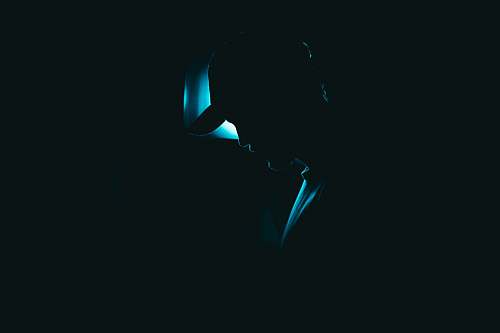 light silhouette of man wearing fitted cap lighting