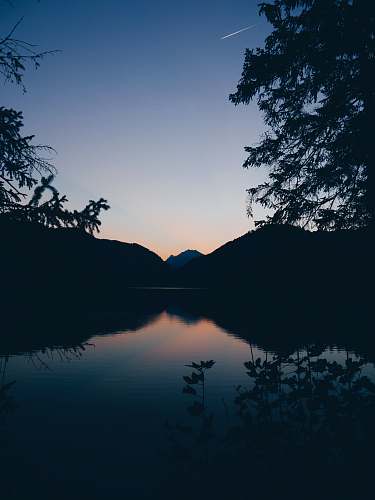 nature silhouette of mountain, lake and trees in nature photography outdoors