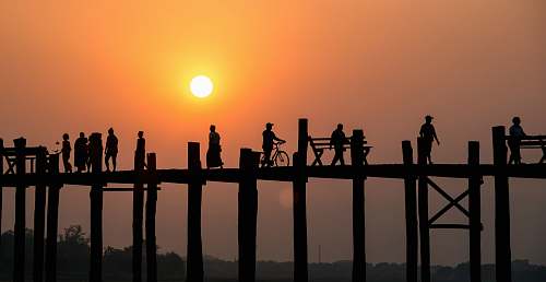 human silhouette of people on bridge person