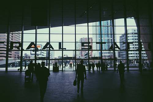 people silhouette of people walking inside Raal Stat building terminal
