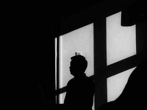 human silhouette of person across wall switch black-and-white