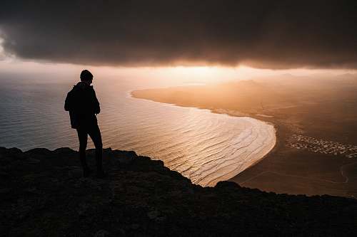 human silhouette of person looking at the horizon person