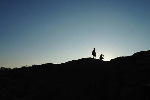 people silhouette of person on hill grey