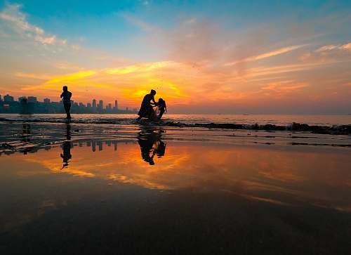 human silhouette of person on seashore person