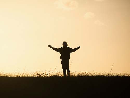 person silhouette of person spreading hands human