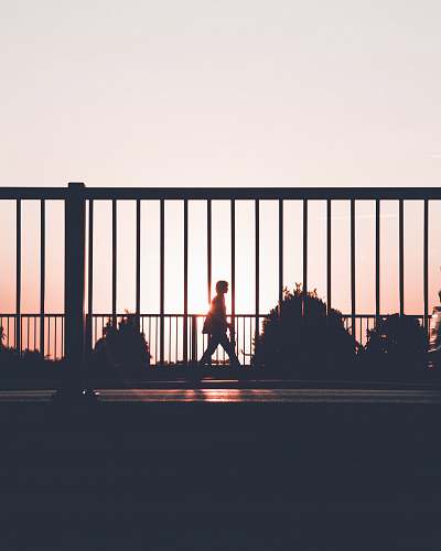 walking silhouette of person walking on roadside during sunset vangede st.