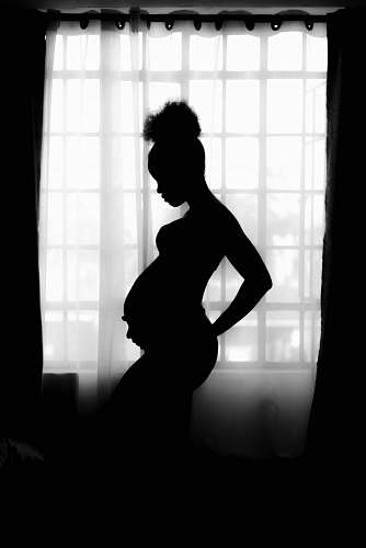 black-and-white silhouette of pregnant woman person