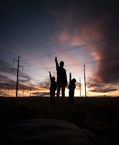 sport silhouette of three person during daytime working out
