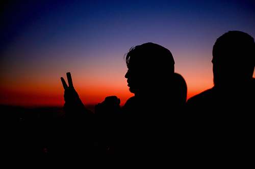 human silhouette of woman holding smartphone person