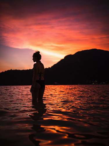nature silhouette of woman in body of water outdoors