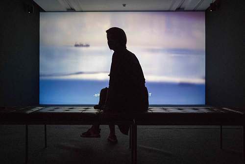 human silhouette of woman sitting on tufted table person