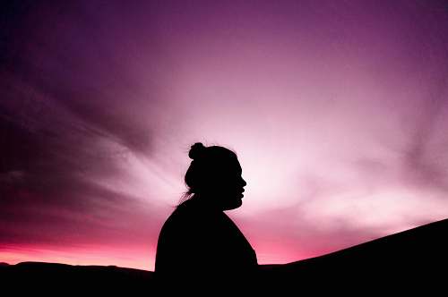 human silhouette of woman under purple sky person
