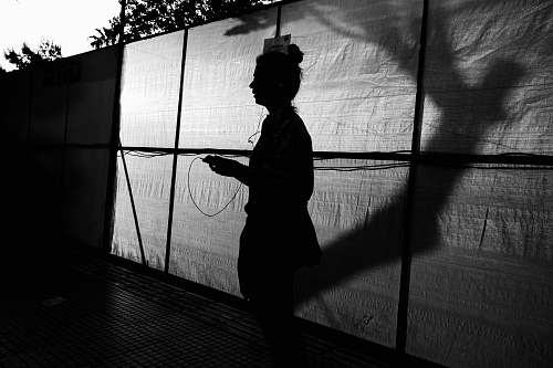 person silhouette of woman wearing hat black-and-white