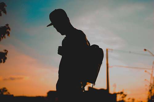 person silhouette photo of a man during golden hour human