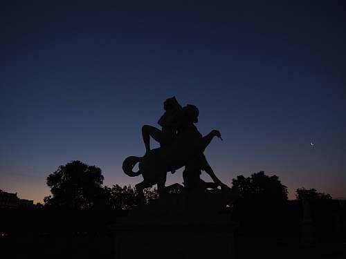 statue silhouette photo of man riding horse statue monument