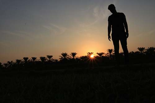 human silhouette photo of man standing on ground person