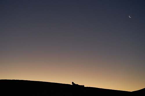 nature silhouette photo of mountains and moon outdoors