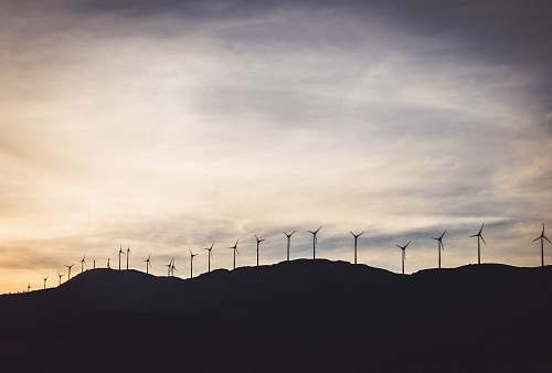 greece silhouette photo of wind turbines on hill turbine