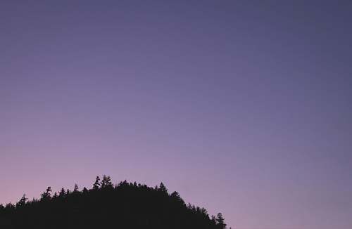 sky silhouette photograph of mountain during dusk grey