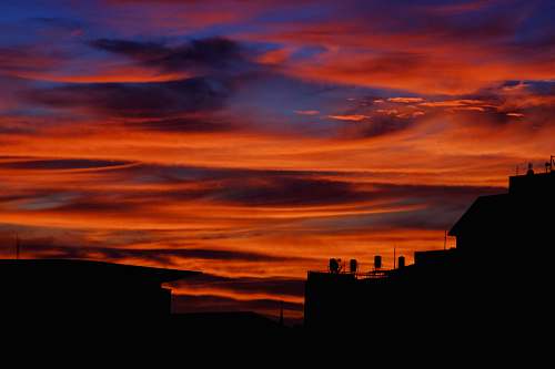 nature silhouette photography of buildings during sunset dawn