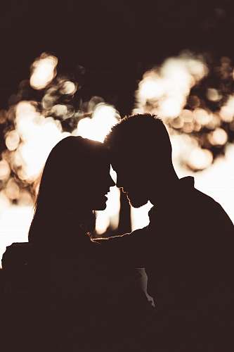 light silhouette photography of couple flare