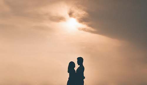 nature silhouette photography of hugging couple during golden hour outdoors
