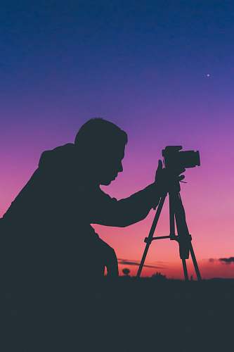 tripod silhouette photography of man talking photo photographer