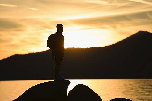 human silhouette photography of person during golden hour person
