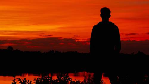 nature silhouette photography of person sunset