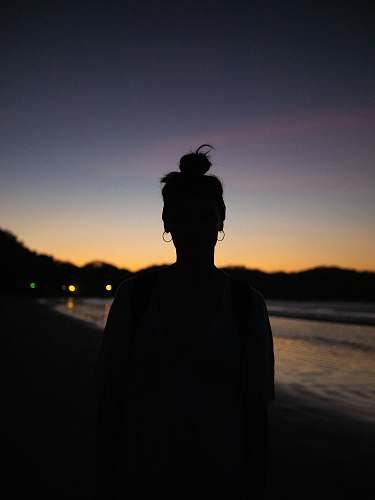 human silhouette photography of person on shore person