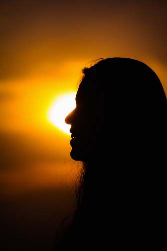 sunlight silhouette photography of smiling woman flare