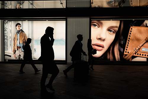 human silhoutte of three persons near billboard people