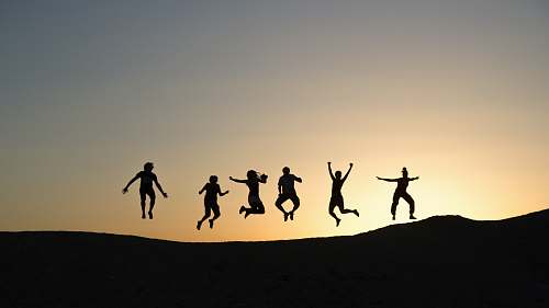 person six silhouette of people jumping during sunrise human