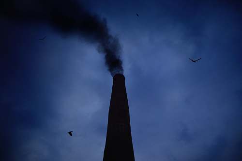 blue smoking chimney during night chimney
