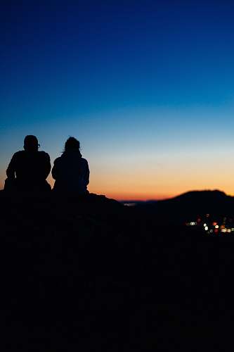 human two silhouette people sitting during sunset people