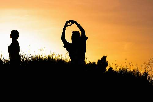 human woman doing heart hand sign person
