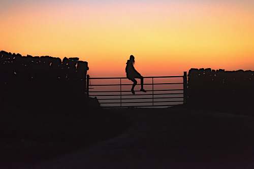 railing woman sitting on fence banister