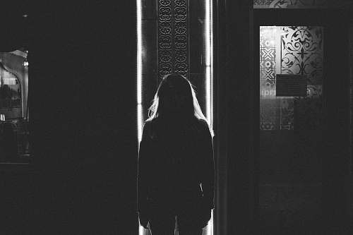 black-and-white woman standing near door inside room bishkek