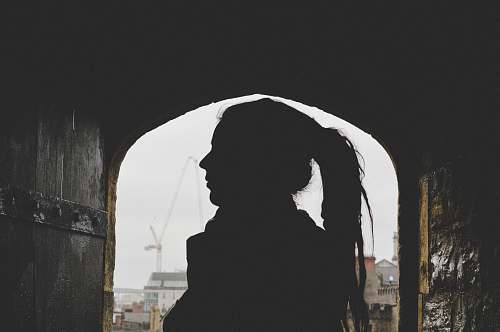 human woman underneath building grey