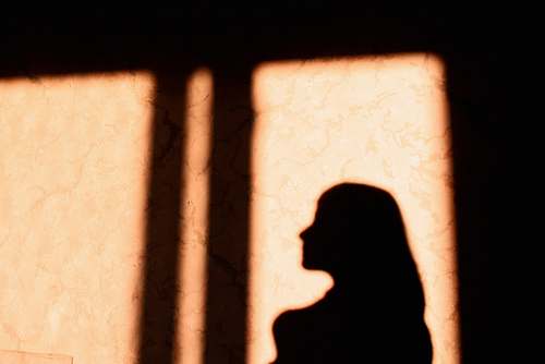 prison woman's shadow window