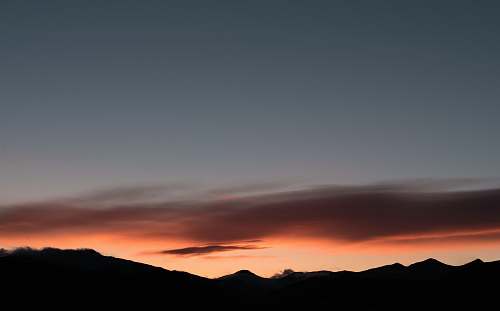 sunset golden hour photography of silhouette of mountain sunrise