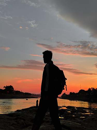 sunset man near shore nature