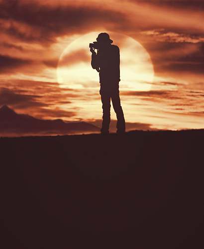 sunrise silhouette of man standing during daytime sunset