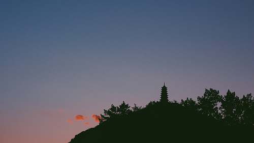 sunrise silhouette of mountain with building sunset