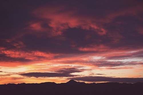 sunrise silhouette photo of mountain during golden hour sunset