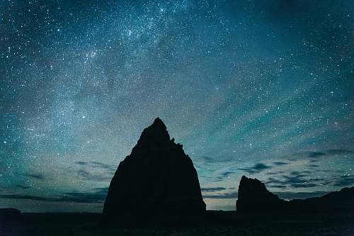 night silhouette of rocky mountain under starry sky universe