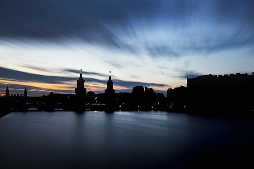 dusk body of water near concrete buildings architecture