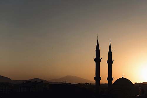 building two mosque minarets under calm sky architecture