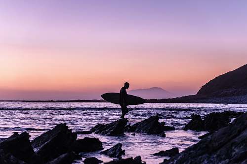 sea man holding surfboard ocean
