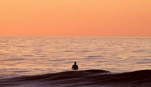 sea silhouette of person in body of water ocean